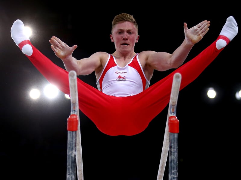Nile Wilson secured a silver medal in the parallel bar at the Commonwealth Games Glasgow 2014 with a score of 15.433.