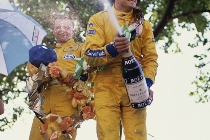 Jean Alesi driver of the #4 Eddie Jordan Racing Reynard 89D Mugen celebrates by spraying champagne after winning the FIA International F3000 Championship Halfords Birmingham Superprix race on 28th August 1989 on the streets of Birmingham, Great Britain. (Photo by Pascal Rondeau/Getty Images)