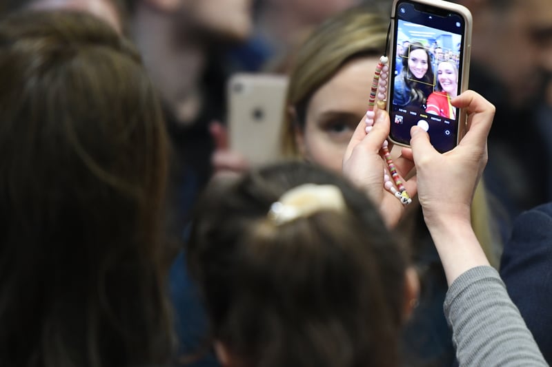 Kate Middleton is captured on a iPhone screen posing for a selfie as she visits the Royal Liverpool University Hospital with Prince William.