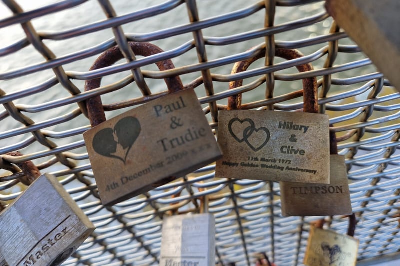 Two padlocks from the early 2000s with one celebrating 50 years of marriage.