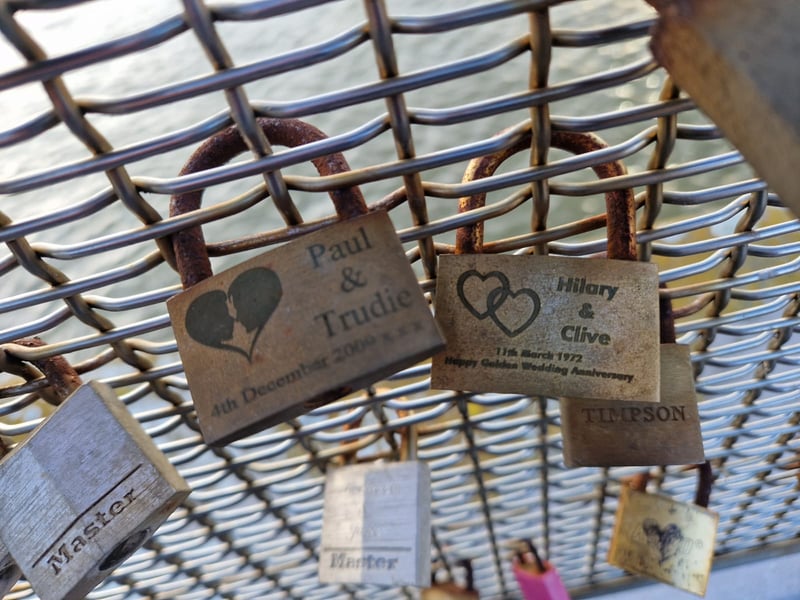 Two padlocks from the early 2000s with one celebrating 50 years of marriage.