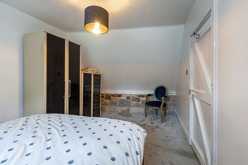 Bedroom 2 features exposed stone and period brickwork