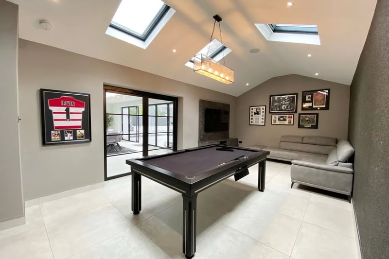 The games room with doors leading to the dining area