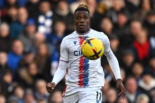 Crystal Palace's Ivorian striker Wilfried Zaha keeps his eyes on the ball during the English Premier League football match between Chelsea and Crystal Palace