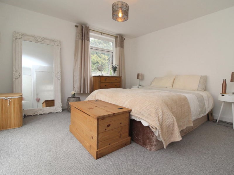 The master bedroom is large and has plenty of space for furniture.