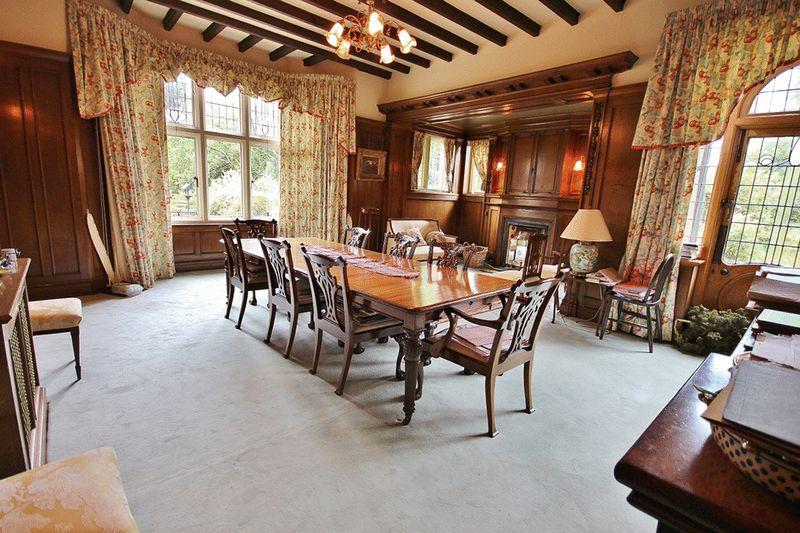 The dining room has beautiful oak panelling and an Inglenook fireplace.