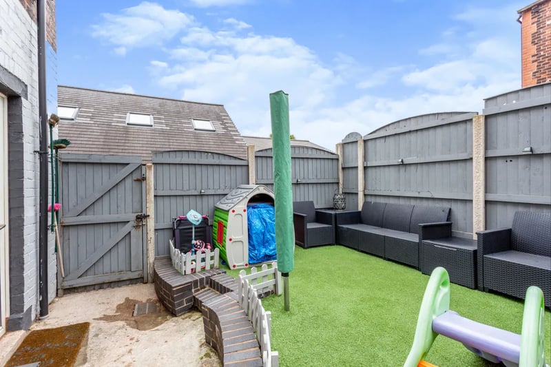 The rear garden with artificial grass and a seating area 