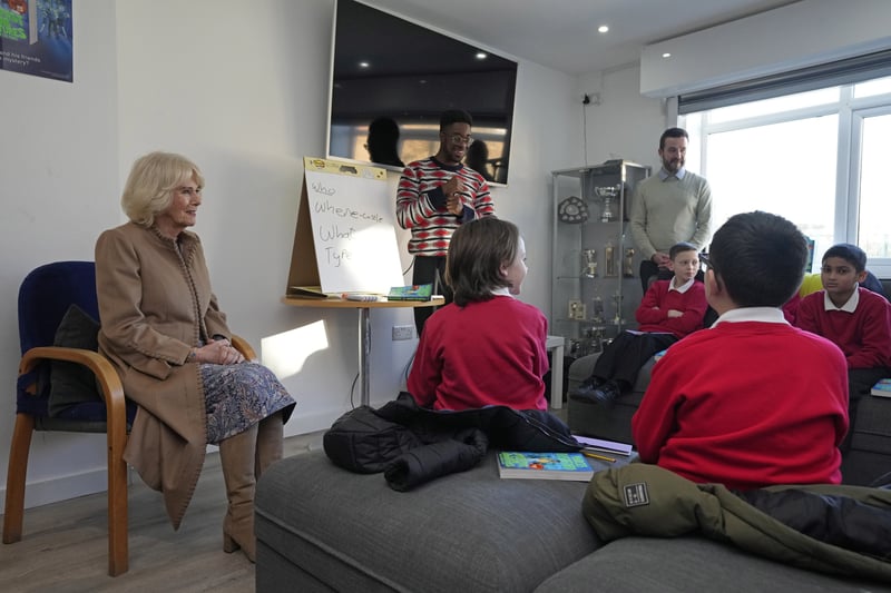 The Queen Consort joins a writing session with author Alex Falase-Koya and children from St Peter’s Primary School during a visit to the Norbrook Community Centre in Wythenshawe