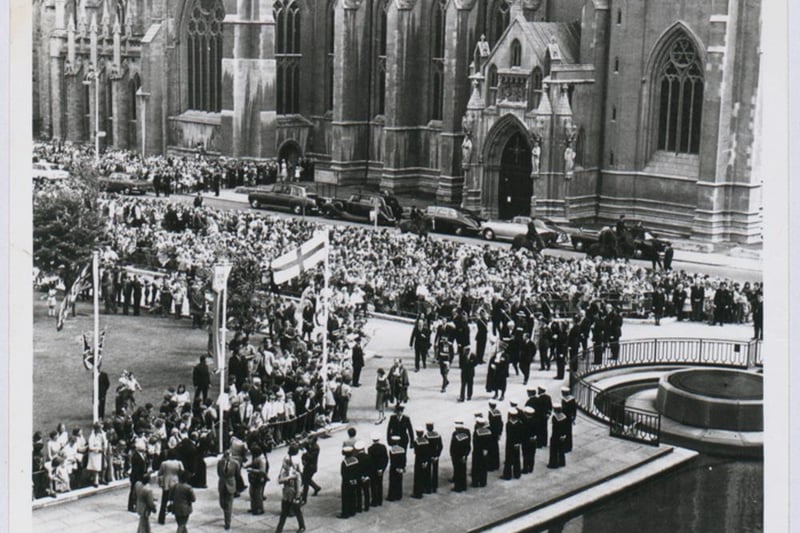 A procession follows Queen Elizabeth II as she visits Bristol during her Silver Jubilee tour in 1977.
