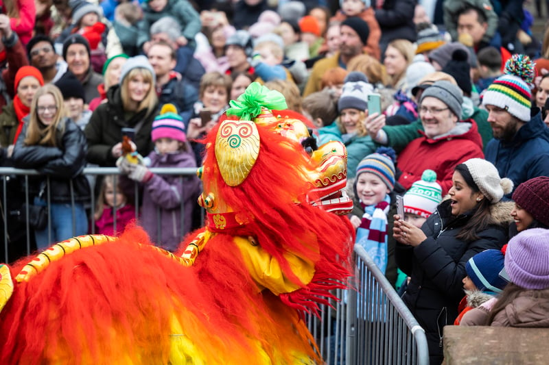 Performers in Manchester’s Chinese New Year parade interact with crowds  outside Manchester Central, where the parade began. Credit: Fabio De Paola/PA Wire