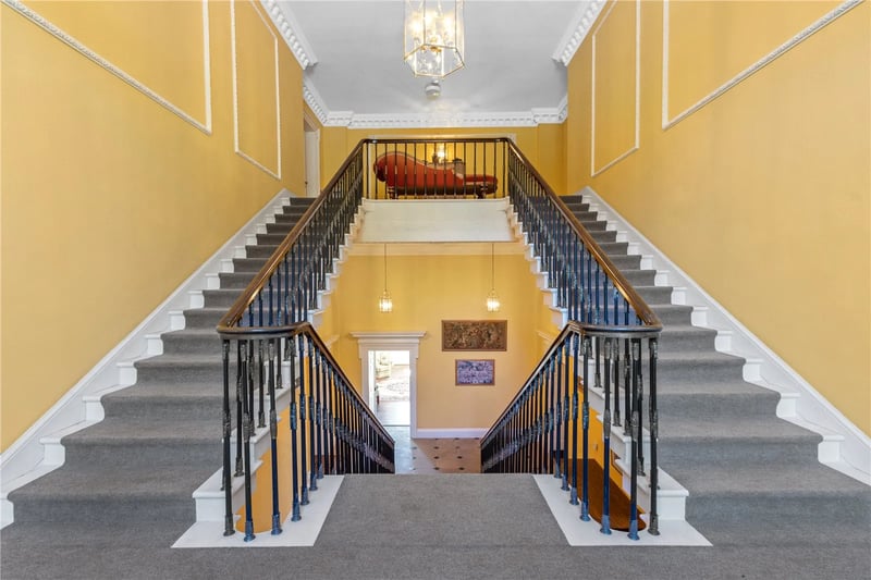 The hallway and stairs leading to the apartment 