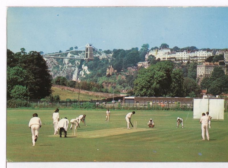 The Bedminster Cricket Club battle on a summer day with the suspension bridge in the background.