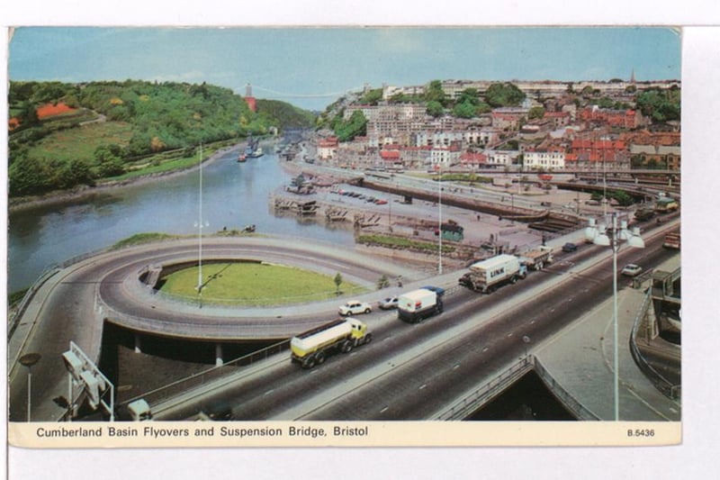 Photograph showing cars and trucks crossing the Cumberland Basin with the Suspension Bridge in the background.