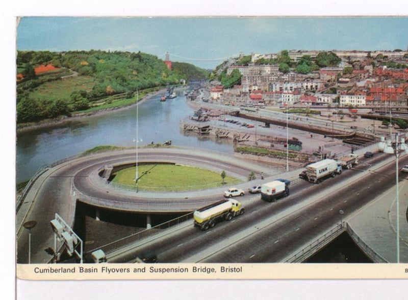 Photograph showing cars and trucks crossing the Cumberland Basin with the Suspension Bridge in the background.