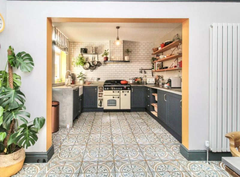 The property has an incredible kitchen diner, with quirky tiles and vertical radiators. 