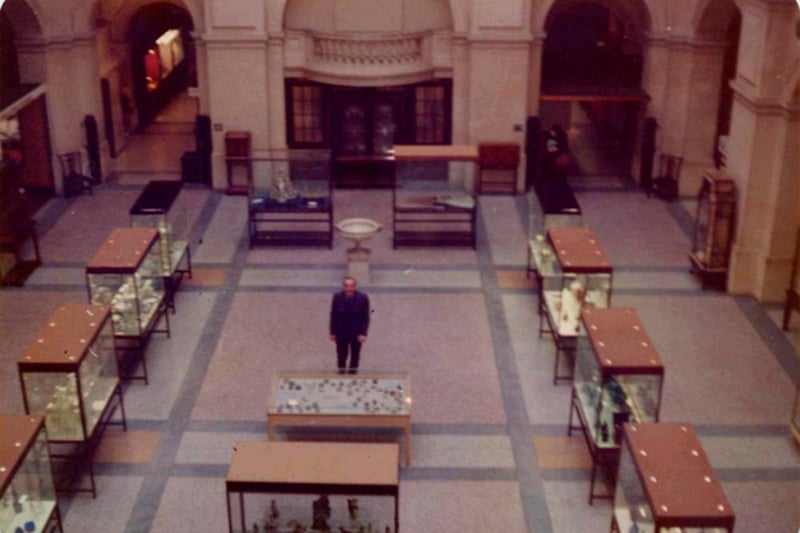 A tour guide stands alone on the ground floor of Bristol Museum.
