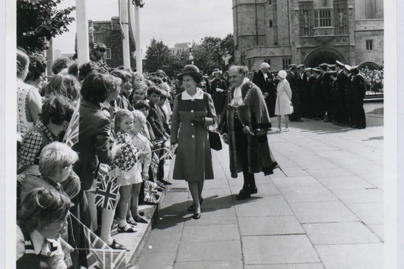 Queen Elizabeth II visited the city during her UK tour to celebrate her Sliver Jubilee. Here she is seen walking along College Green greeting residents.