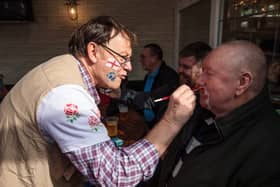 A man has his moustache painted with spots of red as rugby fans gather in the Cabbage Patch pub in Twickenham ahead of the England v Scotland match on March 11, 2017 in London, England.