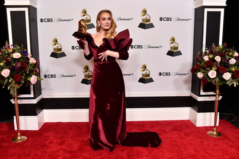 Adele posed with the Best Pop Solo Performance Award for Easy on Me. She wore a glamourous velvet Louis Vuitton dress.