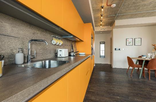 A brightly coloured kitchen area inside one of the apartments