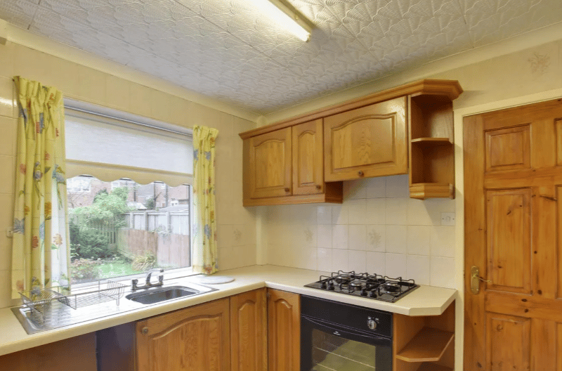 The first image of the kitchen which boasts a standard four hob gas stove, with again great views of the massive garden