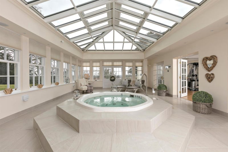 The spa room with a glass ceiling and a jacuzzi.