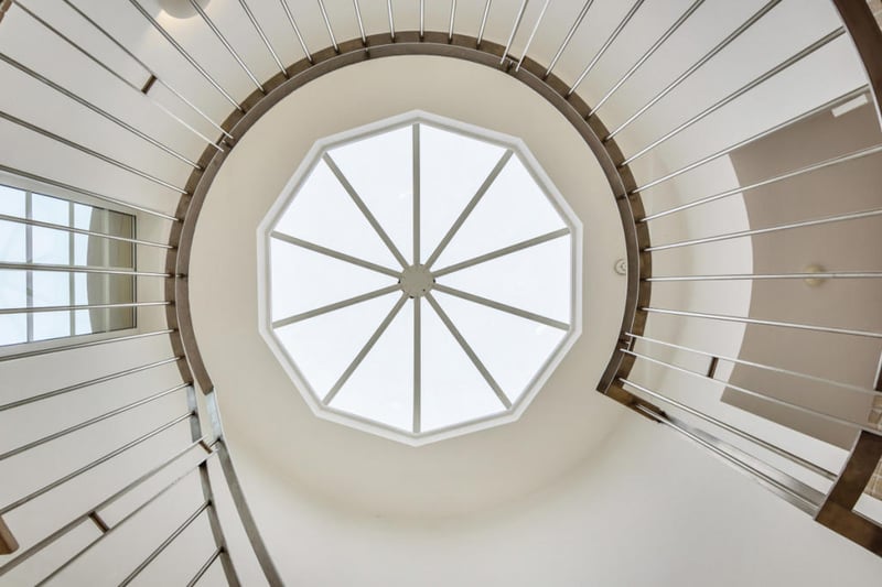A glass ceiling above the spiral stairs.