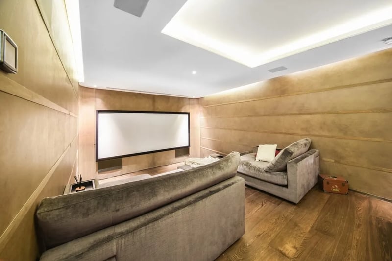 The plush cinema room with reclining sofas