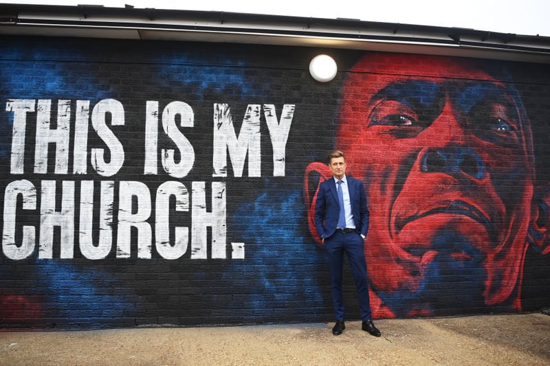Chairman of Crystal Palace stands alongside a mural commemorating musician Maxi Jazz is unveiled outside the stadium prior to the Premier League match 