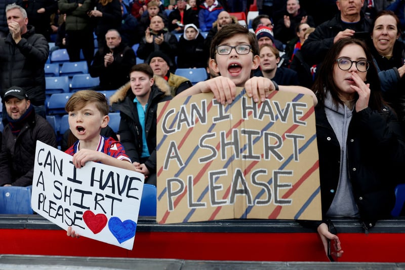 Crystal Palace fans hold banners which read ‘Can I Have A Shirt Please’ prior to the Premier League match