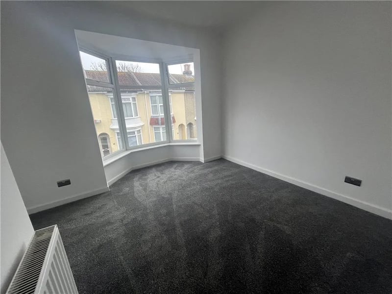 The master bedroom with a large bay window