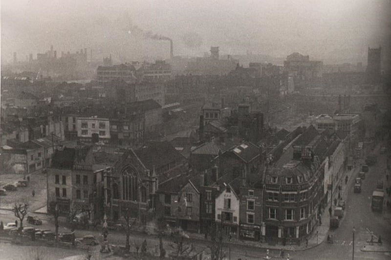 Shops and the Haymarket Hotel (large corner site at junction of Union Street and Horsefair) looking towards the Horsefair from rooftop level, with a glimpse of St James’ Churchyard in the foreground.
