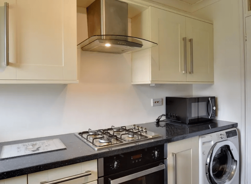 Another view of the kitchen, showcasing sleek furnished cabinets and plenty of storage space