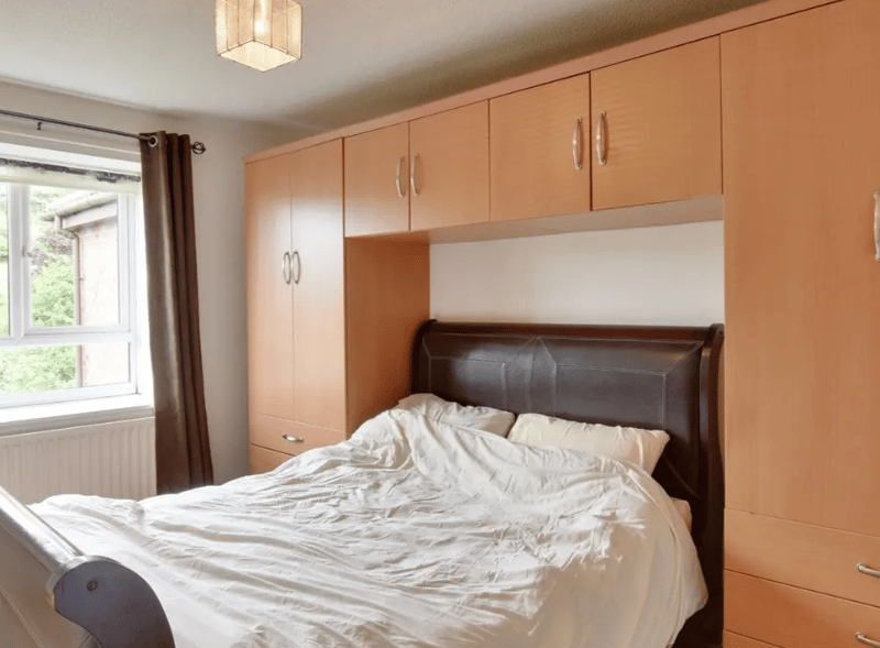 One of two bedrooms pictured here, with fantastic storage space a a huge window