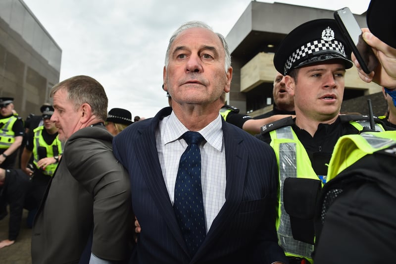 Ex- Rangers chief executive Charles Green leaves court surrounded by police on September 2, 2015 after he was arrested along with Craig Whyte and David Whitehouse on charges of fraudulently acquiring ownership of the club