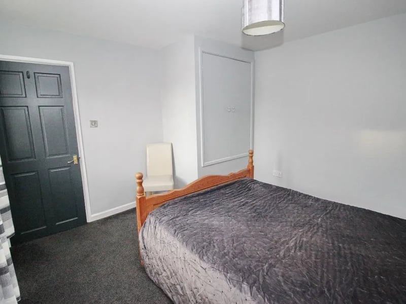 Another angle of the master bedroom with a built in wardrobe