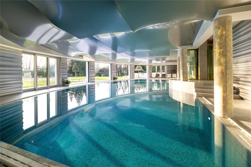 The large indoor swimming pool overlooking the landscaped gardens