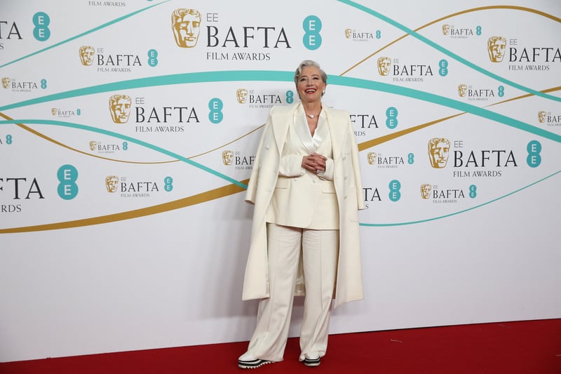 Emma Thompson matched her cream wool coat with her cream wide leg suit by designer Laura Pitharas. She paired with a pair of white trainers, proving you can be stylish and comfortable.