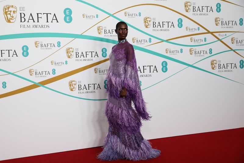 Jodie Turner-Smith turned heads in a stunning purple Gucci gown with dramatic fringe detail. The metallic sheer number was completed with floral appliqué and billowing statement sleeves.