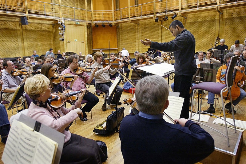 Oscar winner A.R. Rahman, who composed music for Slumdog Millionaire, is pictured here during a rehearsal with The City of Birmingham Symphony Orchestra in March 2004. He conducted two the orchestra in two concert appearances in the UK. He has made music for some of the biggest Bollywood movies including Lagaan, Dil Se, and a lot more. (Photo - ADRIAN DENNIS/AFP via Getty Images)