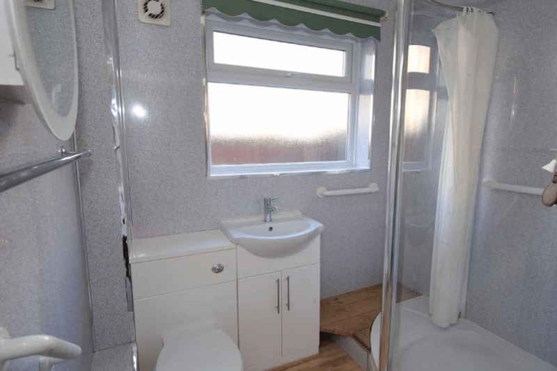 This shower room features a very generous sized shower and good storage space with a double cabinet