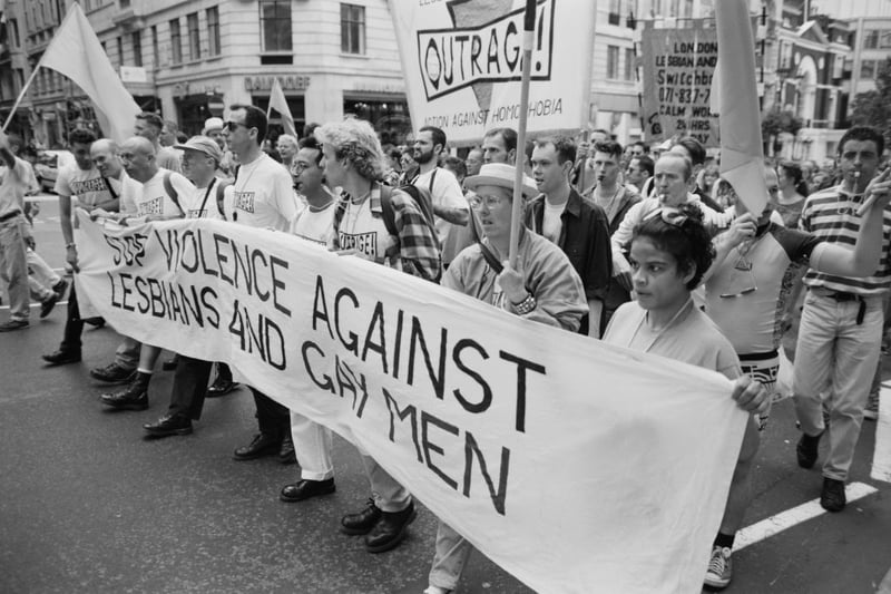 Members of the British LGBT rights group OutRage Marching with a banner reading “Stop Violence Against Lasbians And Gay Men”, at Pride on June 19, 1993. Activist Peter Tatchell is in the front row, fifth from right. (Picture: Steve Eason/Hulton Archive/Getty Images)
