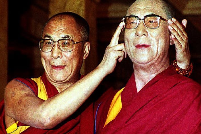 The Dalai Lama toys with his waxwork at Madame Tussaud’s on November 1, 1993 in London. The Dalai Lama brought a pair of his own spectacles for the model on his one-day visit to London. (Picture: Gerry Penny/AFP via Getty Images)