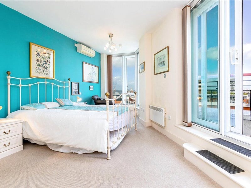 Master bedroom with a balcony