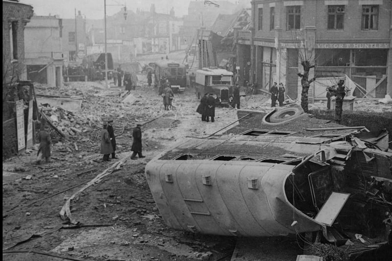 This photograph shows the aftermath of one of the deadliest air raids on Bristol. On the night of March 16/17, many people were killed in the Easton area. A bomb landed at the Lawrence Hill Bus Depot, throwing a bus onto its side and ripping its front off, as pictured.