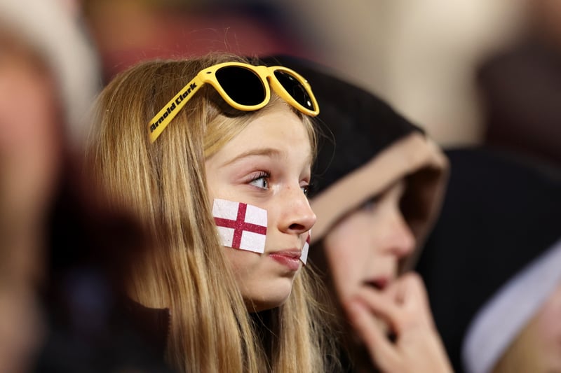 An England fan is fully focused in the action