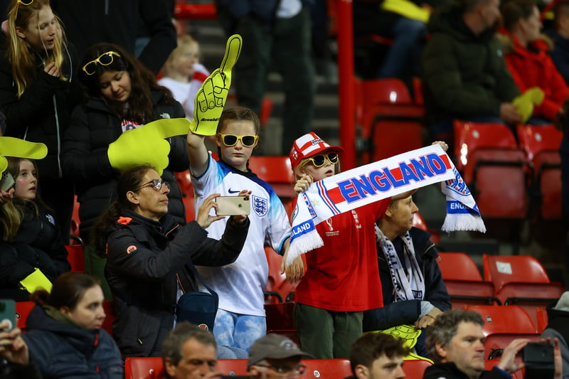 Young England supporters with a foam finger, bucket hat and a scarf