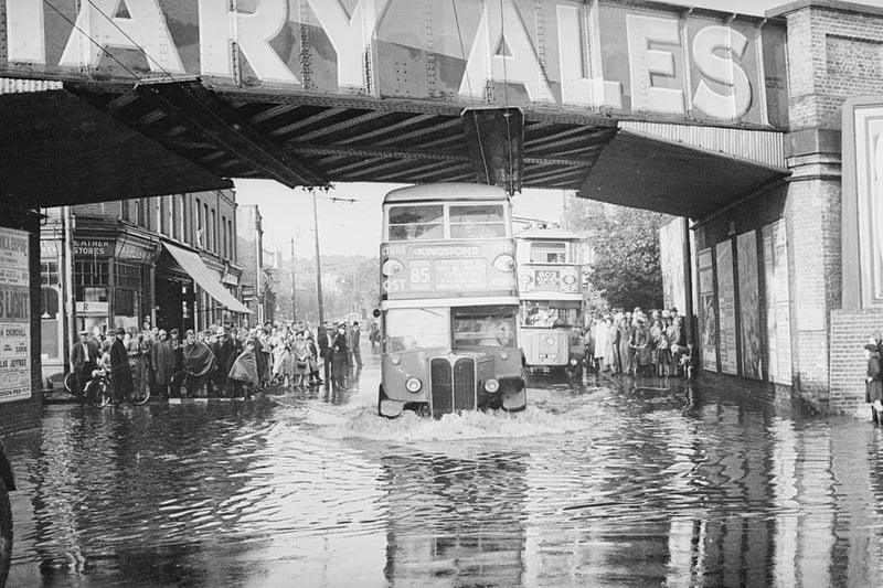 circa 1940:  London buses struggle to maintain a normal service during severe flooding in London.  (Photo by Fox Photos/Getty Images)