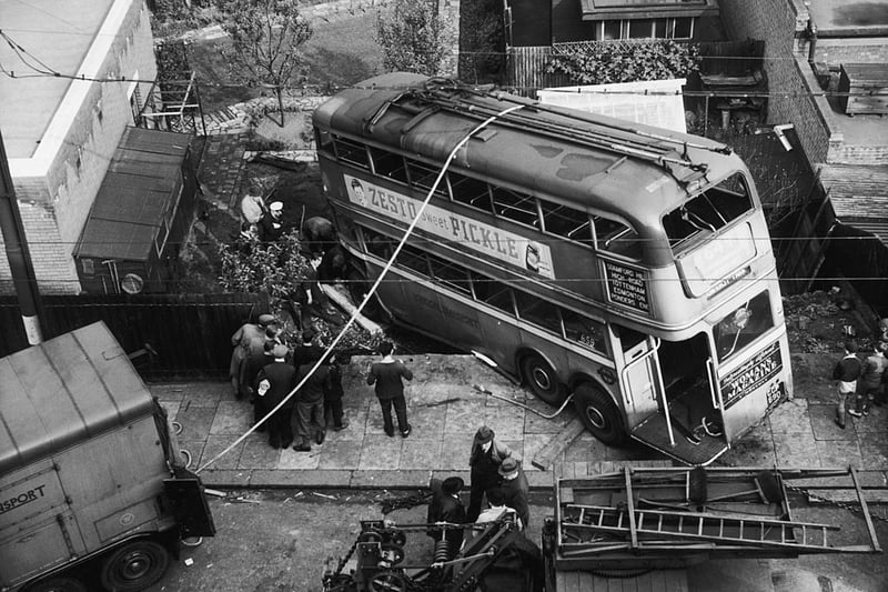The No. 659 trolleybus to Ponders End in a garden on New Road Hill, Edmonton, after crashing through a fence, 21st May 1949. (Photo by Keystone/Hulton Archive/Getty Images)