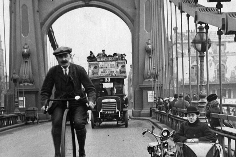 A cyclist riding a penny farthing over Hammersmith Bridge, London.   (Photo by Hulton Archive/Getty Images)